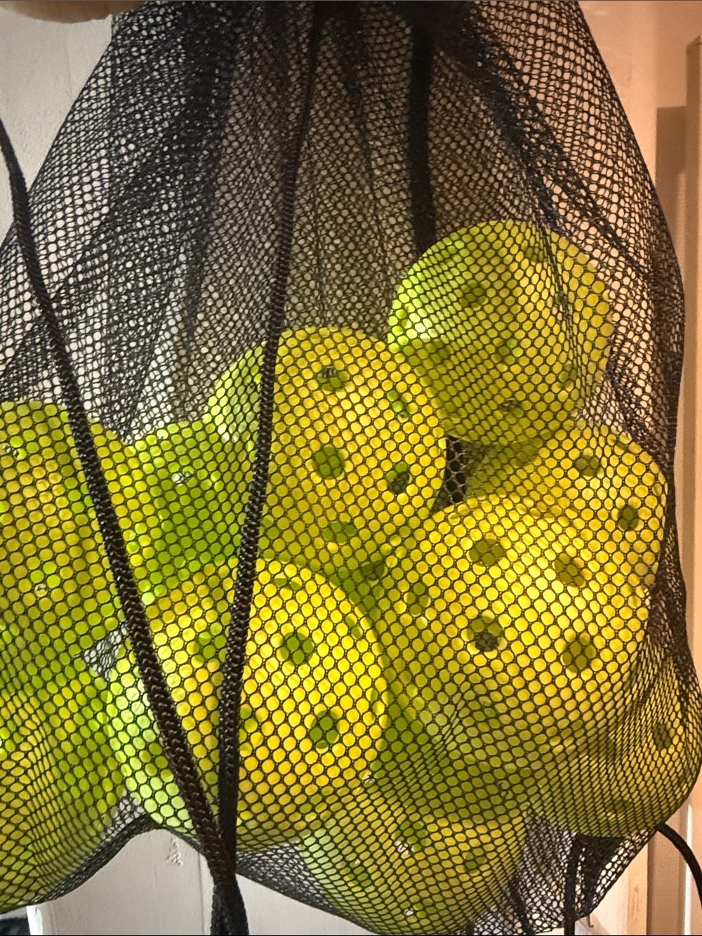Black Mesh Drawstring Tote Bag with Neon Yellow Interior Items